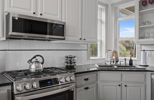 Colington Harbour House | Canal-Front OBX Home w/Dock + Hot Tub/Kayaks/Paddleboards + Bring Your Boat!